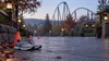 Running shoes and course cones on an empty amusement-park path before dawn.