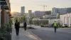 Workers walking through a Tennessee commercial district with construction and health care buildings