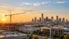 A generic Texas business district and construction site at sunrise, illustrating statewide employment growth.