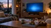 Wooden toys arranged in a living room facing a television with a soft blue screen at dusk