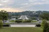 A landscaped traffic circle and stone bridge along the Washington memorial corridor in soft morning light