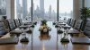 An empty conference table prepared for two delegations in a Manhattan meeting room.