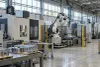 An unbranded advanced-manufacturing floor with computer-controlled machinery and industrial equipment.