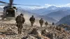 Unidentified soldiers move away from a transport helicopter during a high-altitude training exercise.