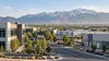 A generic Utah office and light-industrial district beneath the Wasatch Mountains in morning light.