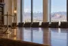Balanced brass scales of justice on a polished table in a generic courthouse room overlooking Utah mountains