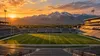 Conceptual view of an empty football stadium with Utah mountain scenery at sunset