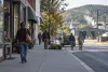 Workers walking through a small Vermont town business district on an autumn morning