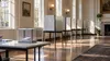 An orderly, empty early-voting room in a generic Virginia civic building with privacy booths and a ballot box.