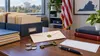 Editorial still life of organized records, a sealed envelope, coins and an old key in a Virginia office setting