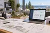 Architectural plans, a housing model and a digital permit-review screen in a Pacific Northwest planning office.
