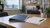 Employment compliance documents and a folder on a workplace break-room table