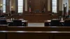Empty New York courtroom viewed from the public gallery after a sentencing hearing
