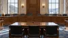 Illustrative empty statehouse hearing room overlooking West Virginia hills