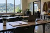 An empty Appalachian community-college classroom with notebooks, a laptop and trade-training equipment.