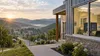 A modern rural clinic with an abstract health-data display overlooking an Appalachian valley