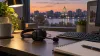 Generic crisis-support workstation with a telephone headset overlooking a Wisconsin city at dusk