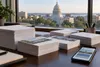 Stacks of blank campaign mailers and envelopes on a desk overlooking the Wisconsin State Capitol