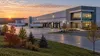 A modern electronics manufacturing facility with loading docks in Wisconsin.