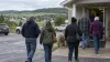 Residents walk into a community hall in rural western Wisconsin on an overcast autumn morning.