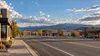 A generic Wyoming commercial district and highway beneath a wide evening sky, with no identifiable businesses or people.