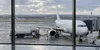 AI-generated illustrative scene of an unbranded passenger jet and fuel truck at an airport gate.