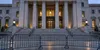 A restrained conceptual view of courthouse steps and a secured entrance, illustrating a federal immigration detention ruling.