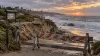 Conceptual illustration of a storm-damaged coastal access path closed by barricades above high surf