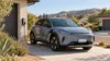 AI-generated illustration of an unbranded electric car connected to a charger in a generic California residential driveway; not a photograph of a rebate recipient.