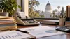 Illustrative California state finance desk with calculator and Capitol dome