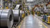 Illustrative view of steel coils and unfinished vehicle bodies inside a modern Ontario manufacturing plant