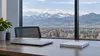 AI-generated editorial image of an unbranded office desk overlooking distant Colorado foothills.