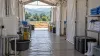 AI-generated editorial view of an empty temporary field-treatment corridor prepared with handwashing and protective supplies.
