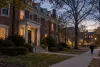 Illustrative view of a quiet collegiate residence and a campus safety officer at dusk
