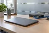 AI-generated illustrative photograph of an unbranded laptop and network equipment in a generic office; not an actual federal facility.
