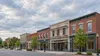 A generic small Mid-Atlantic downtown block with brick mixed-use buildings and one facade under renovation.