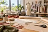 AI-generated fashion worktable illustration; not either college, its students or an actual collection.