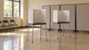 AI-generated editorial illustration of empty generic voting privacy booths in a community room; not a photograph of a Georgia polling location or actual election equipment.