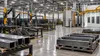 Illustrative view of a modern metal-fabrication floor with unbranded steel components and inactive equipment.