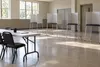 AI-generated illustration of an empty, generic voting room with privacy screens; not a photograph of a Louisiana polling place or an election event.