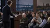 Illustrative image of a government official listening to a voter at a civic town hall