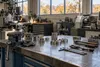 AI-generated illustration of an unoccupied manufacturing workbench in an Upper Midwest industrial setting; not a photograph of a particular Minnesota employer or layoff.