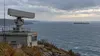 AI-generated illustration of a generic coastal radar overlooking a commercial ship at sea; not an actual Black Sea location or NATO deployment.