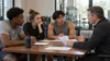 Three student-athletes meet with a college athletics administrator in an unbranded campus training facility.