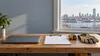 Illustrative small-business workbench with laptop, clipboard, tape measure and gloves