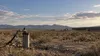 AI-generated editorial image of an unbranded groundwater well pipe in a broad southern New Mexico desert construction landscape.