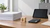 Illustrative office desk with forms, child-care block, calculator and blank tablet representing New York regulatory modernization; AI-generated image.