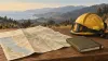 AI-generated conceptual illustration of an emergency notebook, unmarked map and helmet; not the Norte Fire or an official evacuation map.