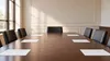 AI-generated editorial illustration of empty chairs around a generic public meeting table with blank papers; not a photograph of Oklahoma’s Judicial Nominating Commission.