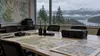 A quiet Pacific Northwest emergency-planning room with radios, maps and a rugged equipment case.